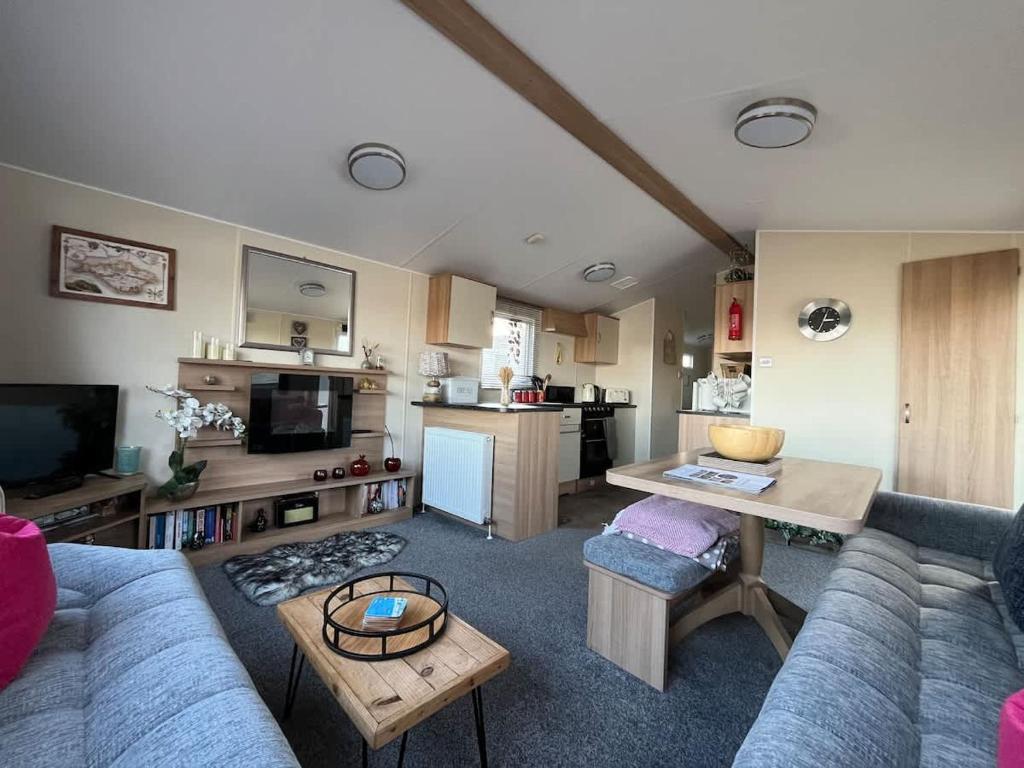 a living room with a couch and a table at Beachlands in Porchfield