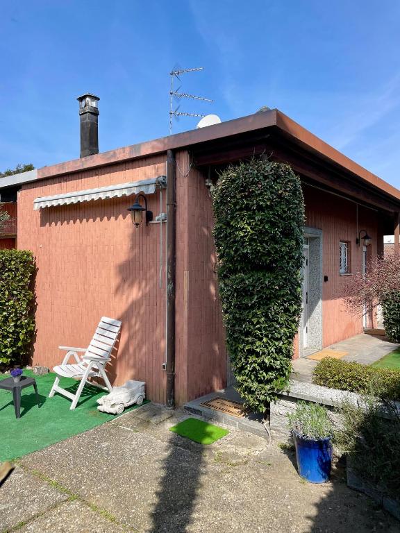 a wooden shed with a chair in front of it at Bnbook Martina's house in Castelletto sopra Ticino
