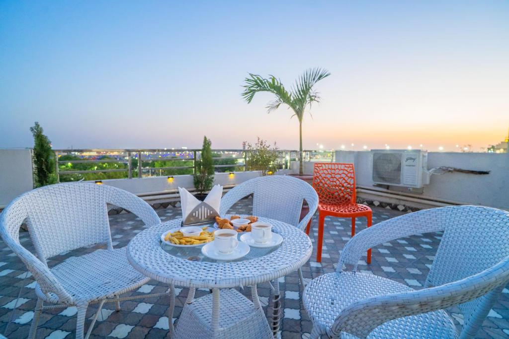 a table and chairs with a plate of food on a patio at HOTEL SNOOZE in Jaipur