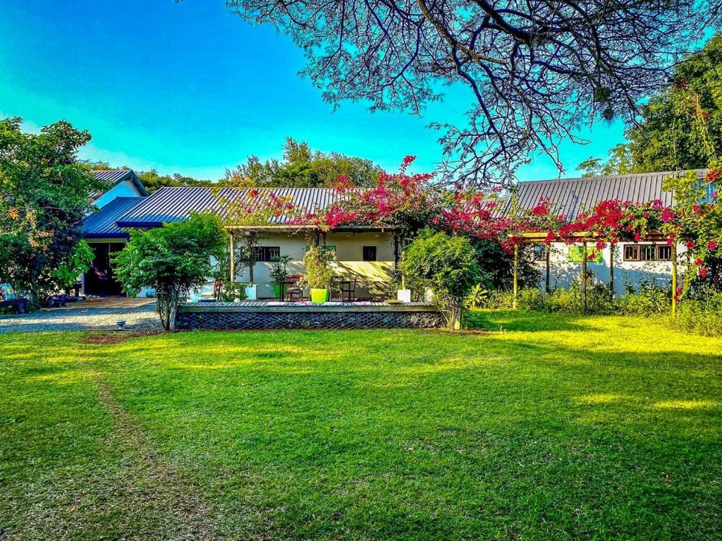 a house with a garden in front of it at Hluhluwe Homestead in Hluhluwe