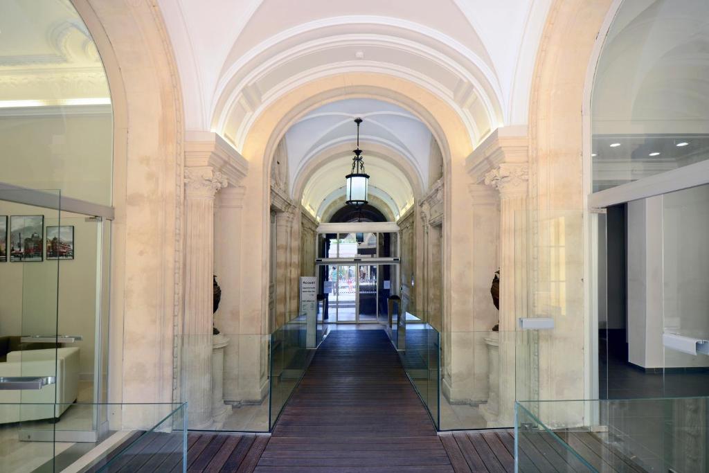 a hallway in a building with an archway at Odalys City Montpellier Les Occitanes in Montpellier