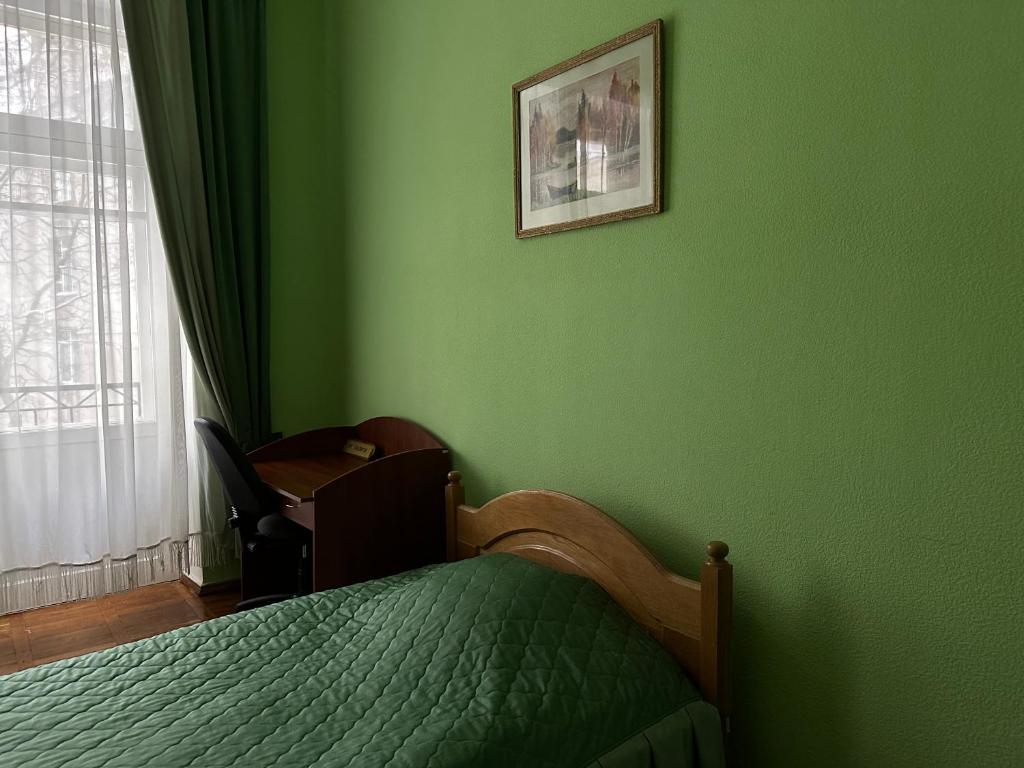 Postel nebo postele na pokoji v ubytování Sikorsky Hotel
