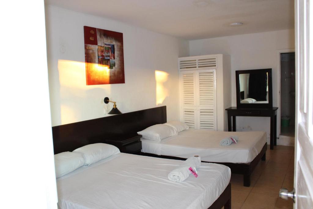 Postel nebo postele na pokoji v ubytování OYO Hotel Colibri