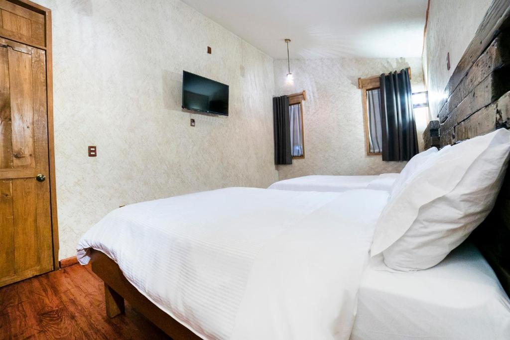 Postel nebo postele na pokoji v ubytování Collection O Casona De Minas