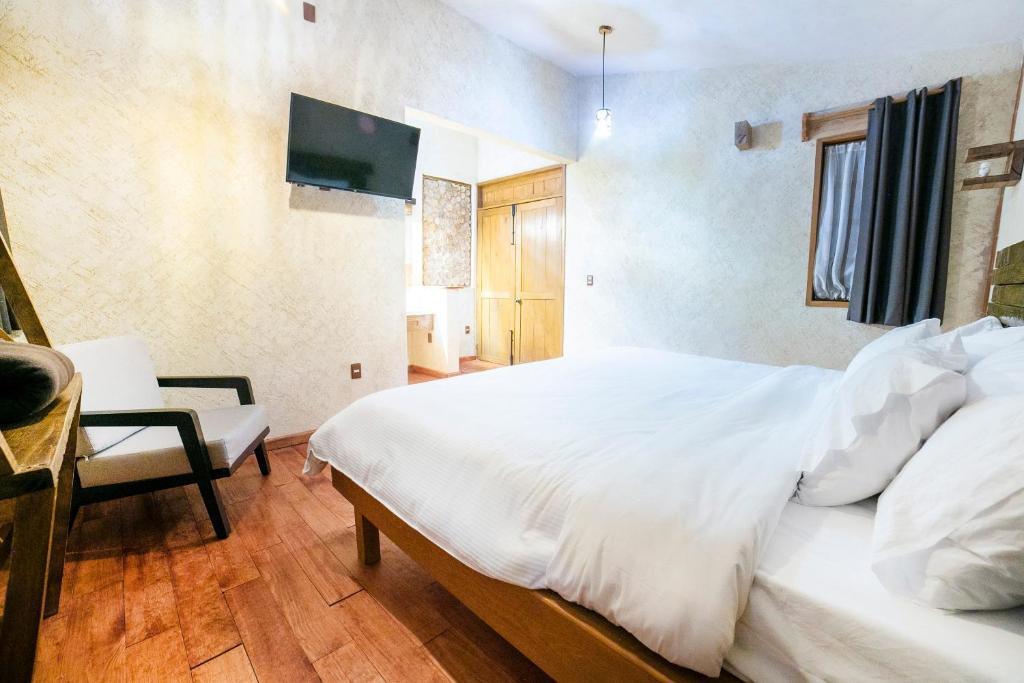 Postel nebo postele na pokoji v ubytování Collection O Casona De Minas