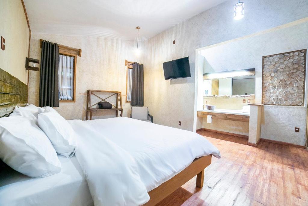 Postel nebo postele na pokoji v ubytování Collection O Casona De Minas