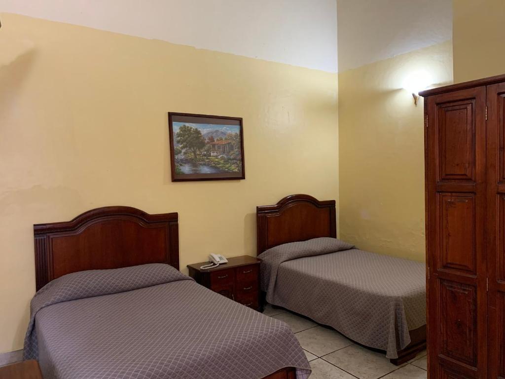 Postel nebo postele na pokoji v ubytování OYO Hotel Real de Cortés