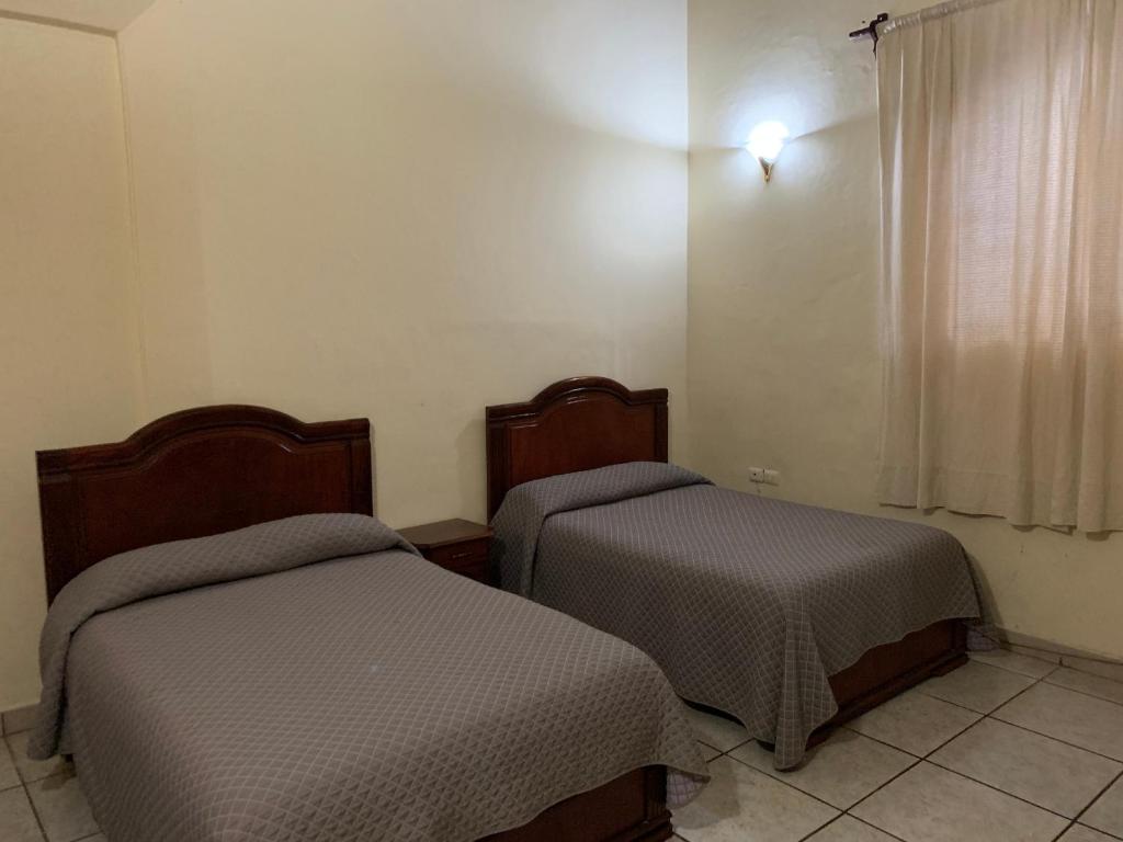 Postel nebo postele na pokoji v ubytování OYO Hotel Real de Cortés