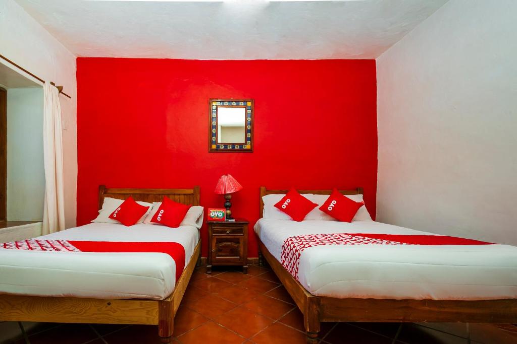 Postel nebo postele na pokoji v ubytování OYO Posada De Los Angeles, Pátzcuaro