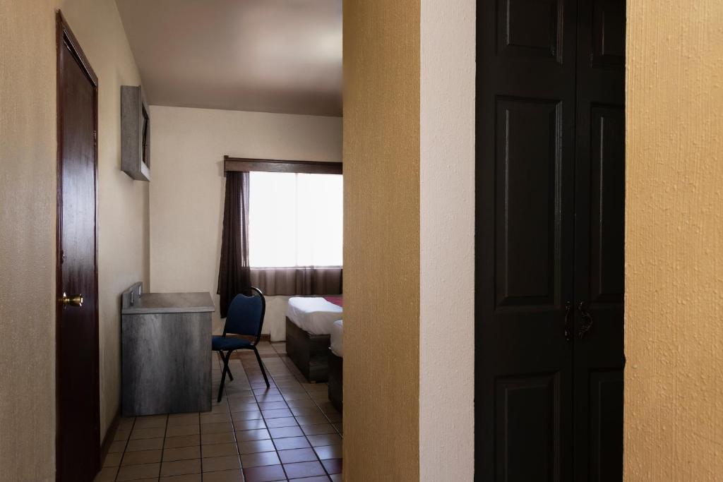 Postel nebo postele na pokoji v ubytování OYO Hotel Real Del Sur, Estadio Chihuahua
