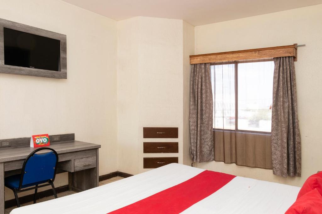 Postel nebo postele na pokoji v ubytování OYO Hotel Real Del Sur, Estadio Chihuahua