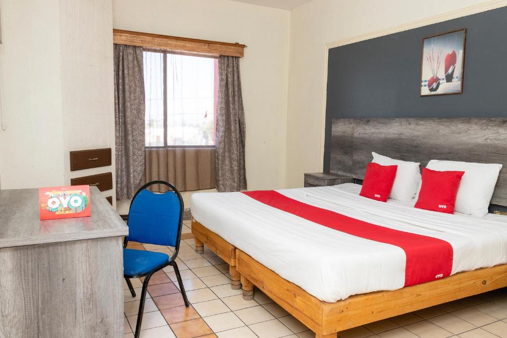 Postel nebo postele na pokoji v ubytování OYO Hotel Real Del Sur, Estadio Chihuahua