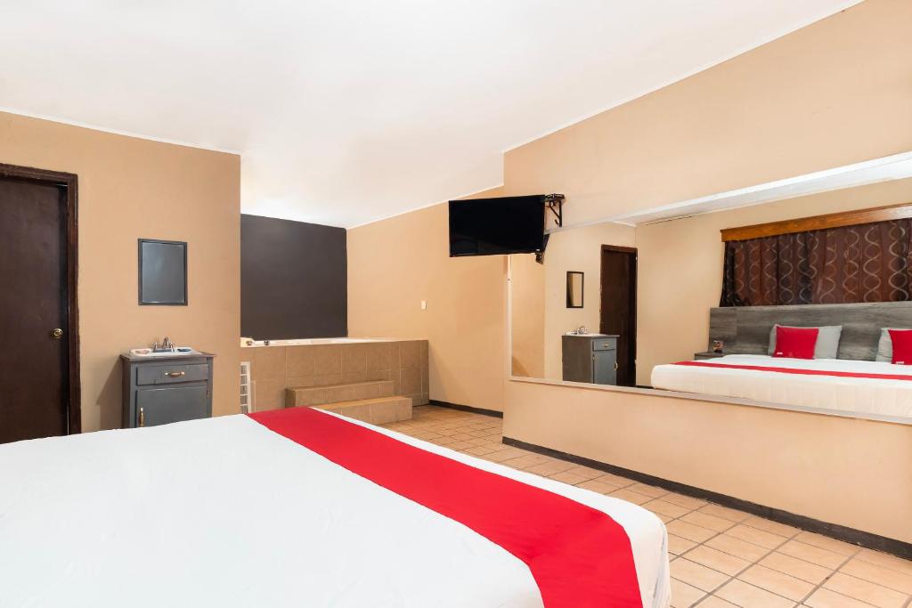 Postel nebo postele na pokoji v ubytování OYO Hotel Real Del Sur, Estadio Chihuahua