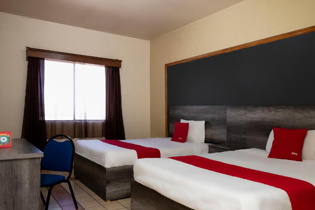 Postel nebo postele na pokoji v ubytování OYO Hotel Real Del Sur, Estadio Chihuahua