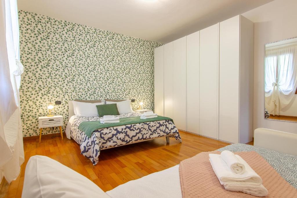 a small bedroom with two beds and a window at CASA OLIVIA Private garden & Parking in Vicenza