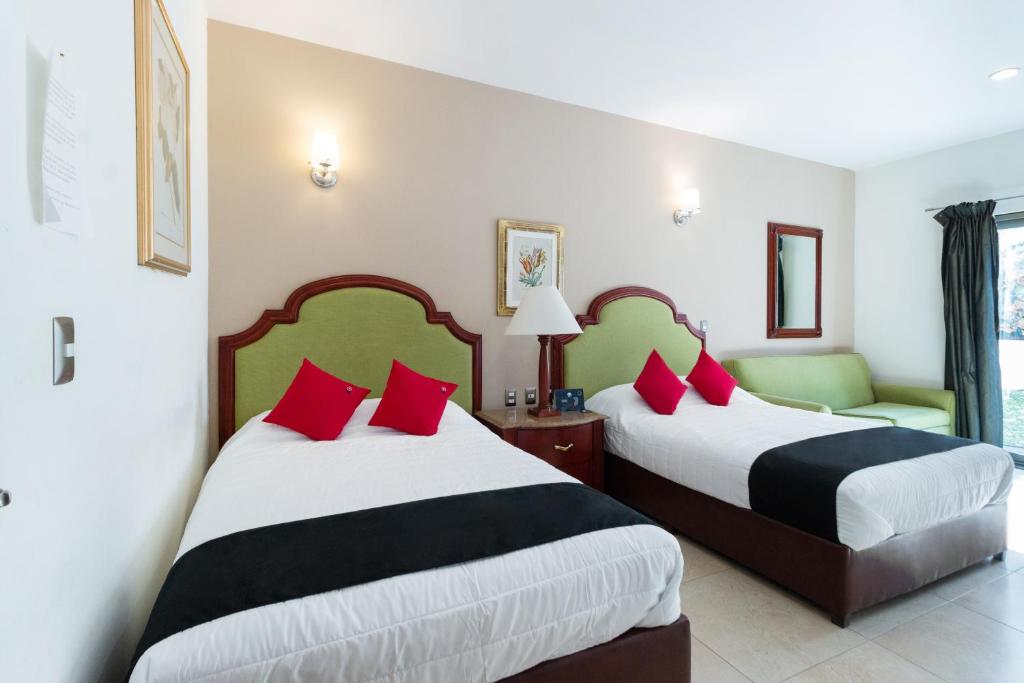 Postel nebo postele na pokoji v ubytování Capital O Hotel Vitalé