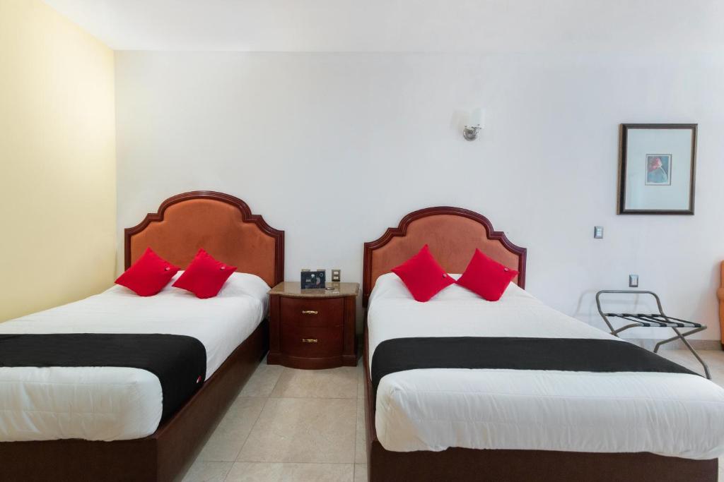 Postel nebo postele na pokoji v ubytování Capital O Hotel Vitalé