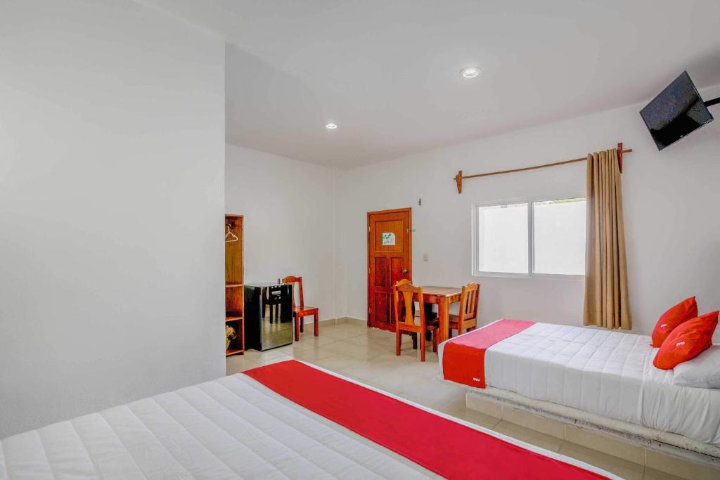 Postel nebo postele na pokoji v ubytování OYO Hotel Palma Real