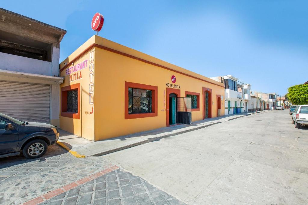 a street with cars parked on the side of a building at OYO Hotel Y Restaurante Mitla, Oaxaca in San Pablo Villa de Mitla