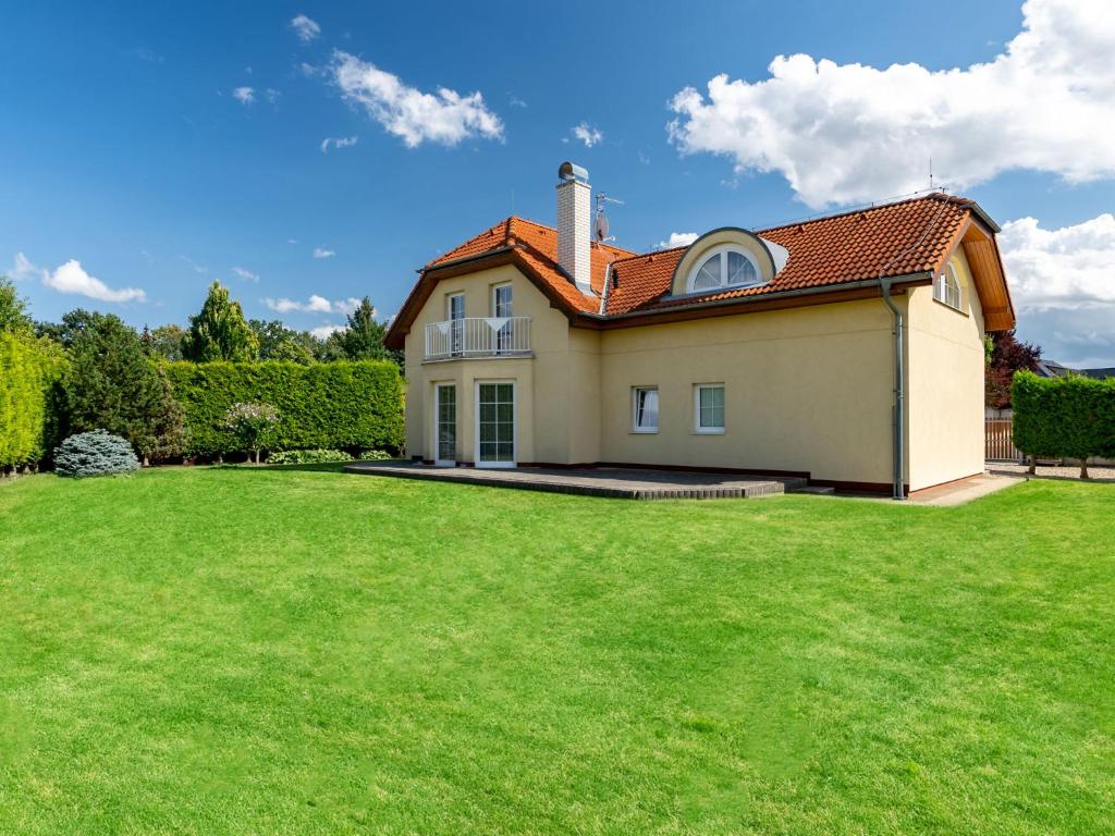 a house with a green lawn in front of it at Villa Garden & Terrace Villa by Interhome in Prague