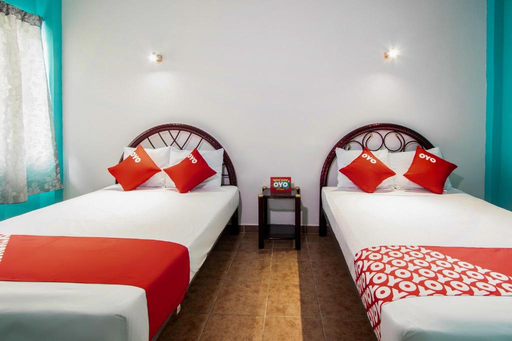 Postel nebo postele na pokoji v ubytování OYO Hotel Estacion,José Cardel,Parque Central Revolución
