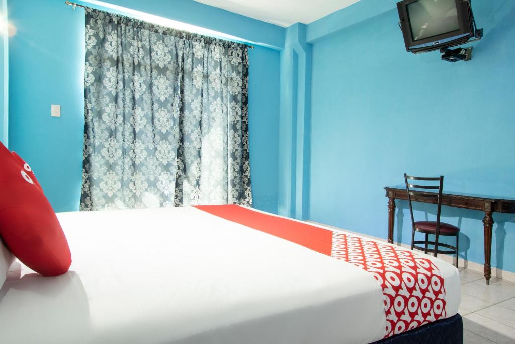 Postel nebo postele na pokoji v ubytování OYO Hotel Estacion,José Cardel,Parque Central Revolución