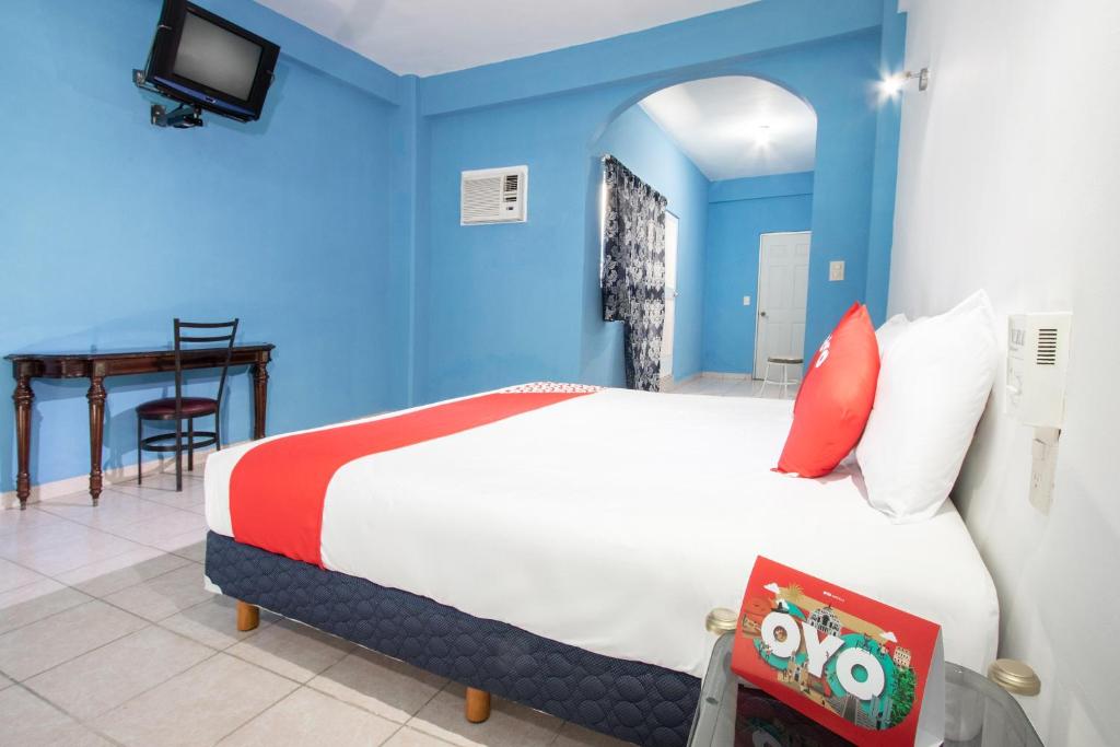 Postel nebo postele na pokoji v ubytování OYO Hotel Estacion,José Cardel,Parque Central Revolución
