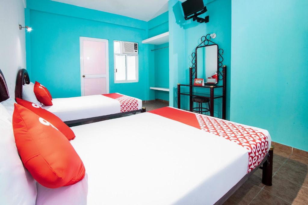 Postel nebo postele na pokoji v ubytování OYO Hotel Estacion,José Cardel,Parque Central Revolución