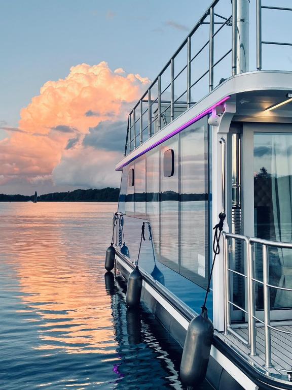 a boat is docked at a dock on the water at Nena Hausboot in Berlin