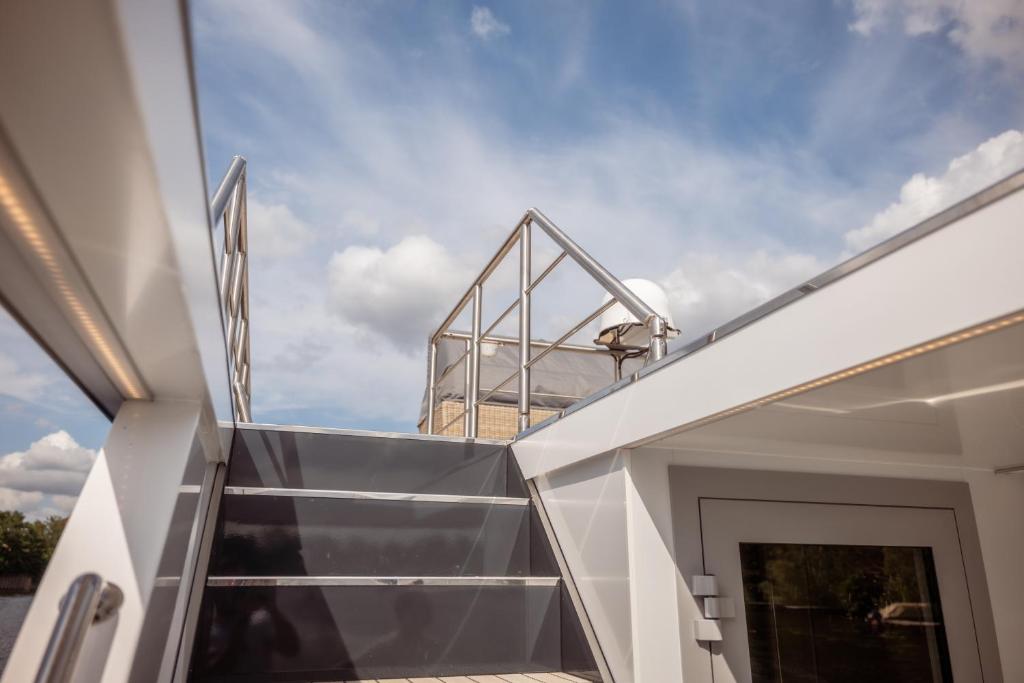 a pivot door on the roof of a house at Nena Hausboot in Berlin