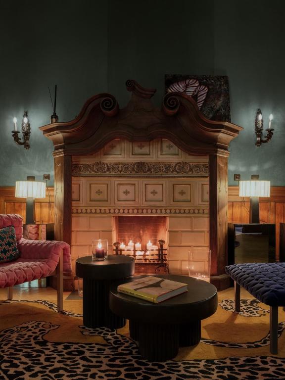 a living room with a fireplace and a couch at The Benjamin House in Rīga