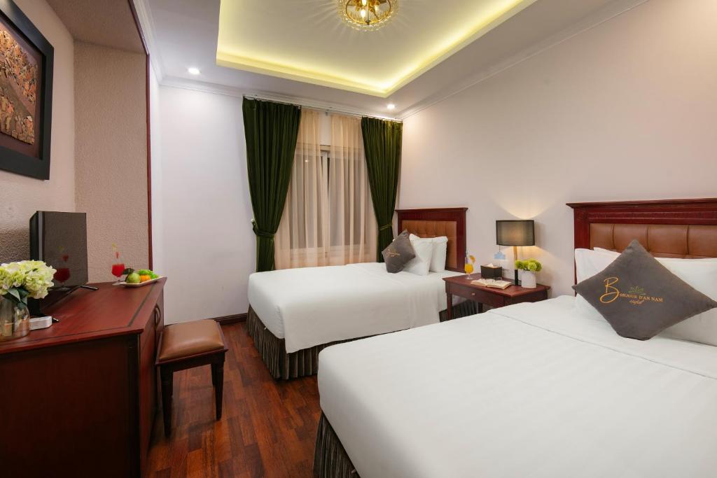 Postel nebo postele na pokoji v ubytování Bonjour D'An Nam Hotel