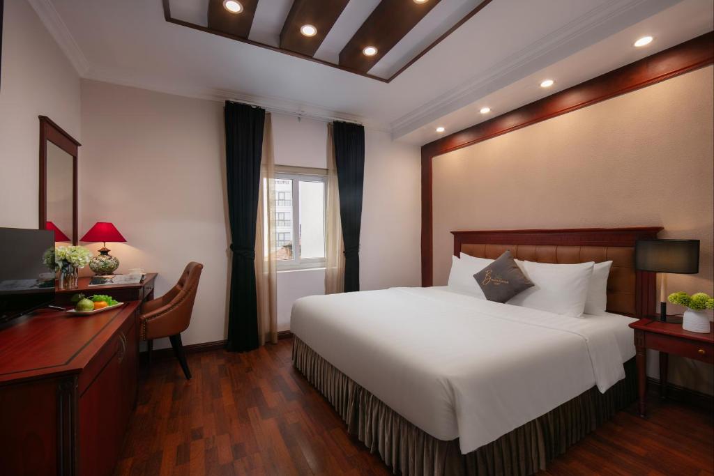 Postel nebo postele na pokoji v ubytování Bonjour D'An Nam Hotel