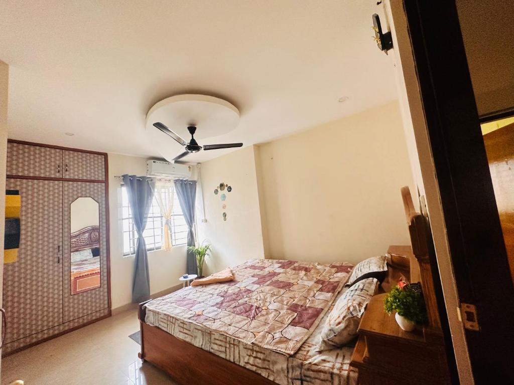a bedroom with a bed and a ceiling fan at Elite 7 in Guwahati