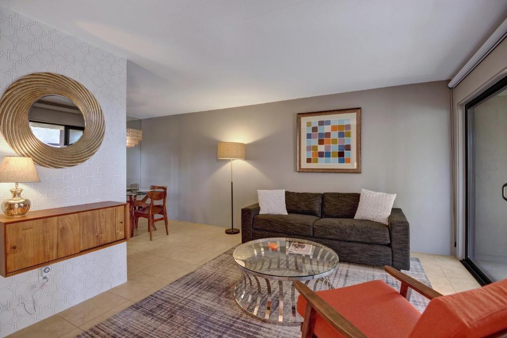 a living room with a couch and a table at Biarritz Getaway - 1br condo downtown PS in Palm Springs