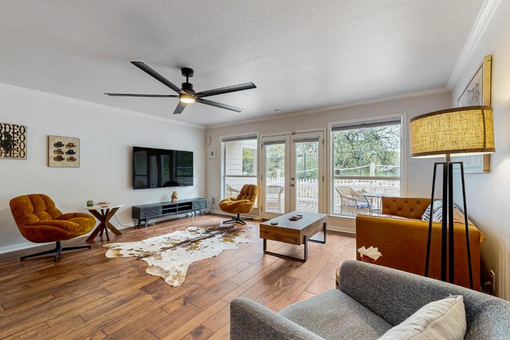 a living room with a couch and a ceiling fan at ‘Lakeside Getaway’ w/ Patio on Lady Bird Lake in Austin