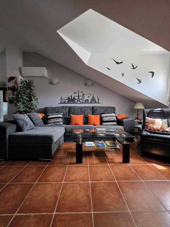 a living room with a couch and a table at El ático de María in Ruidera