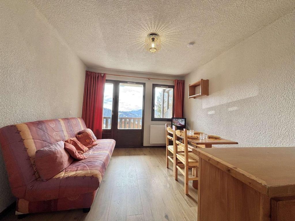 un salon avec un canapé et une table dans l'établissement Studio cosy à 50m des pistes, balcon, parking, casier à skis, proche village et école de ski - FR-1-595-11, à Notre-Dame-de-Bellecombe