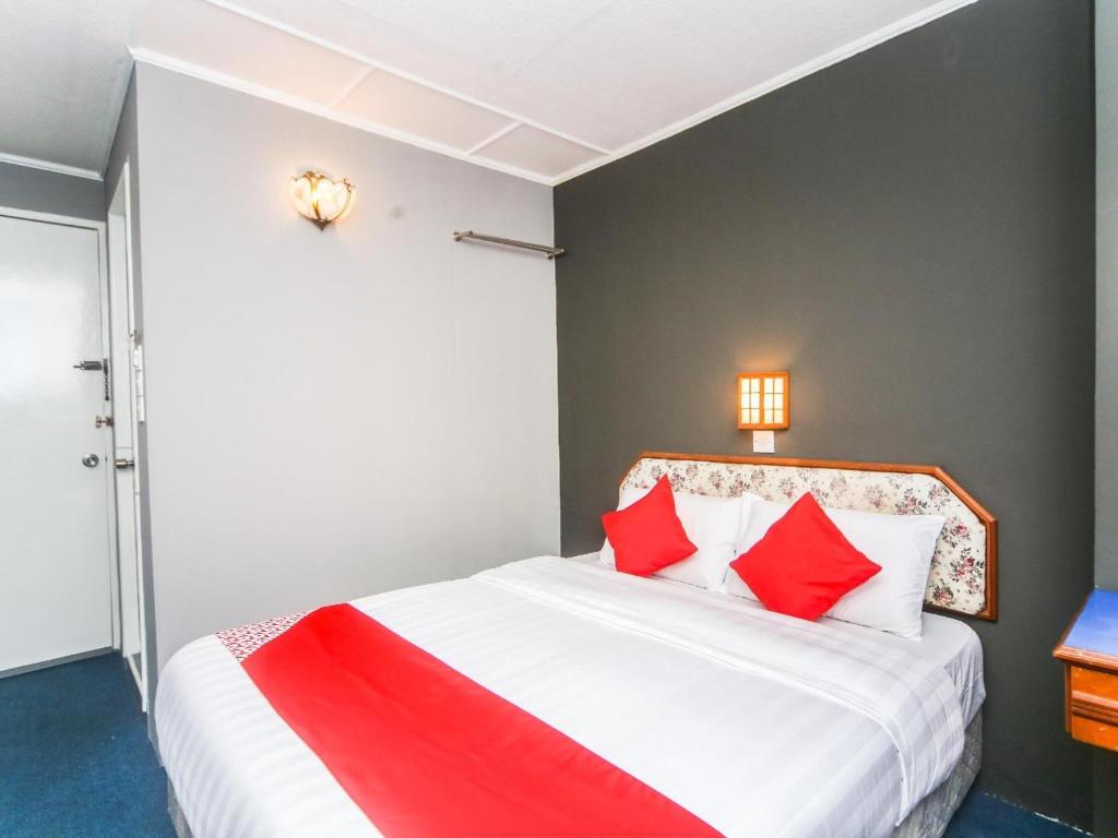 Postel nebo postele na pokoji v ubytování Super OYO 1026 Hotel Lutana