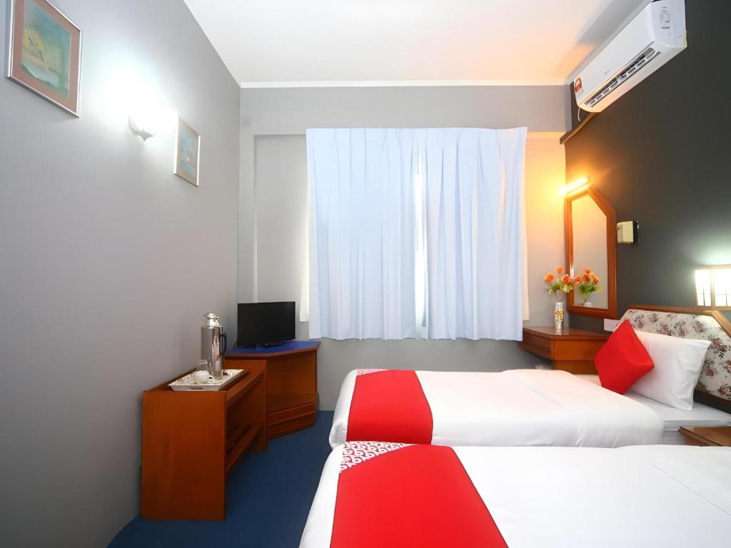 Postel nebo postele na pokoji v ubytování Super OYO 1026 Hotel Lutana