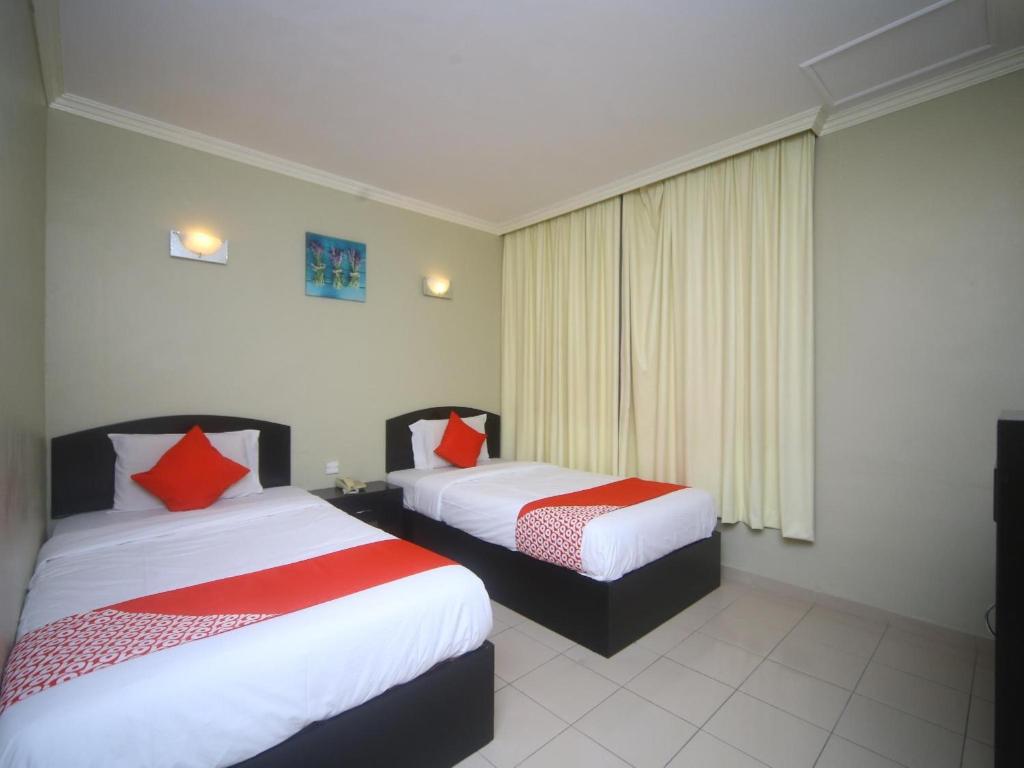 Postel nebo postele na pokoji v ubytování Super OYO 1027 Hotel London