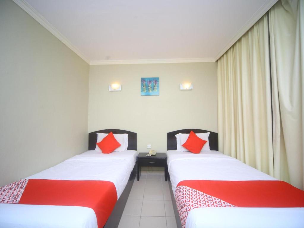 Postel nebo postele na pokoji v ubytování Super OYO 1027 Hotel London