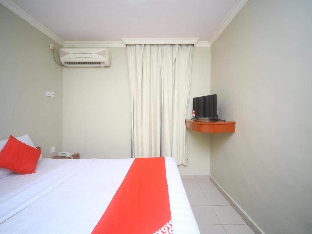 Postel nebo postele na pokoji v ubytování Super OYO 1027 Hotel London