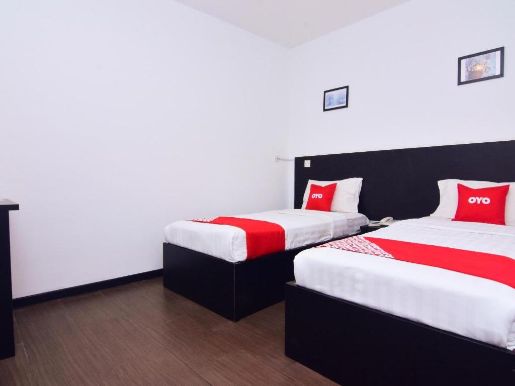 Postel nebo postele na pokoji v ubytování Super OYO 43959 Astana Hotel