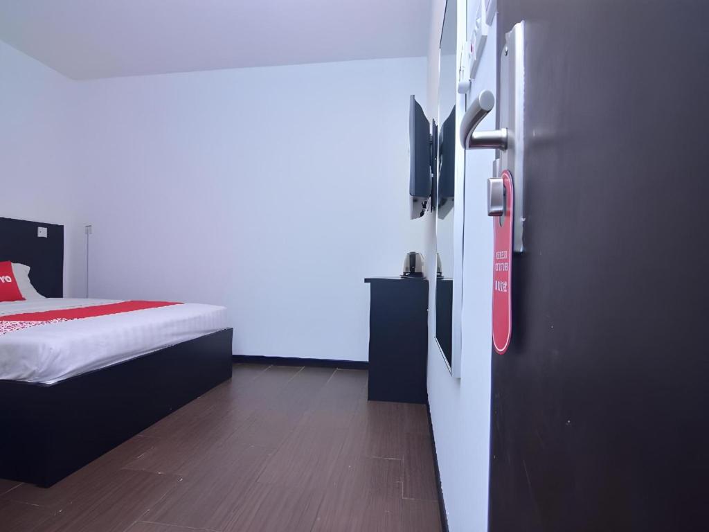 Postel nebo postele na pokoji v ubytování Super OYO 43959 Astana Hotel