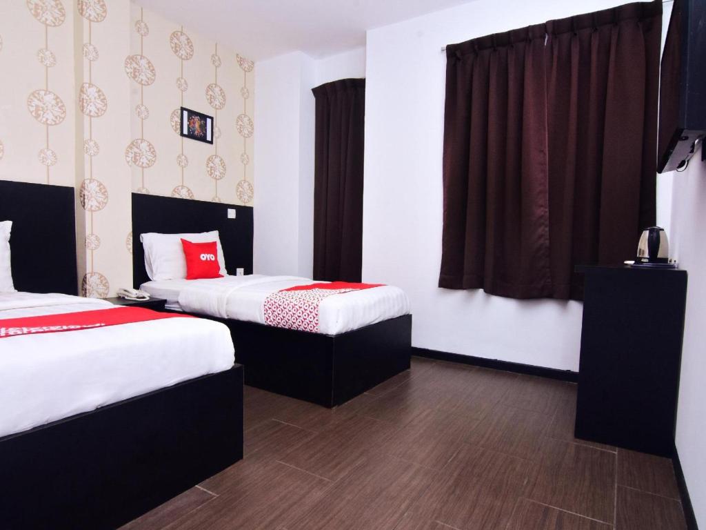 Postel nebo postele na pokoji v ubytování Super OYO 43959 Astana Hotel