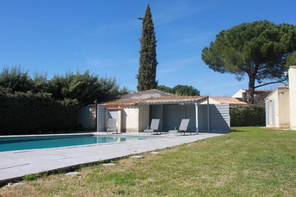 a backyard with a swimming pool and a house at Villa avec piscine dans le Luberon in La Tour-dʼAigues