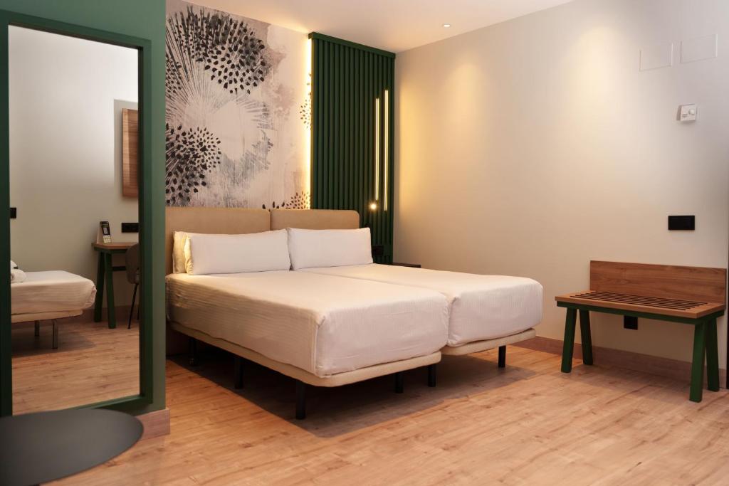 A bed or beds in a room at Sercotel Princesa De Eboli