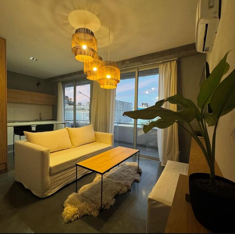 a living room with a white couch and a table at Espacio Garibaldi in Chivilcoy