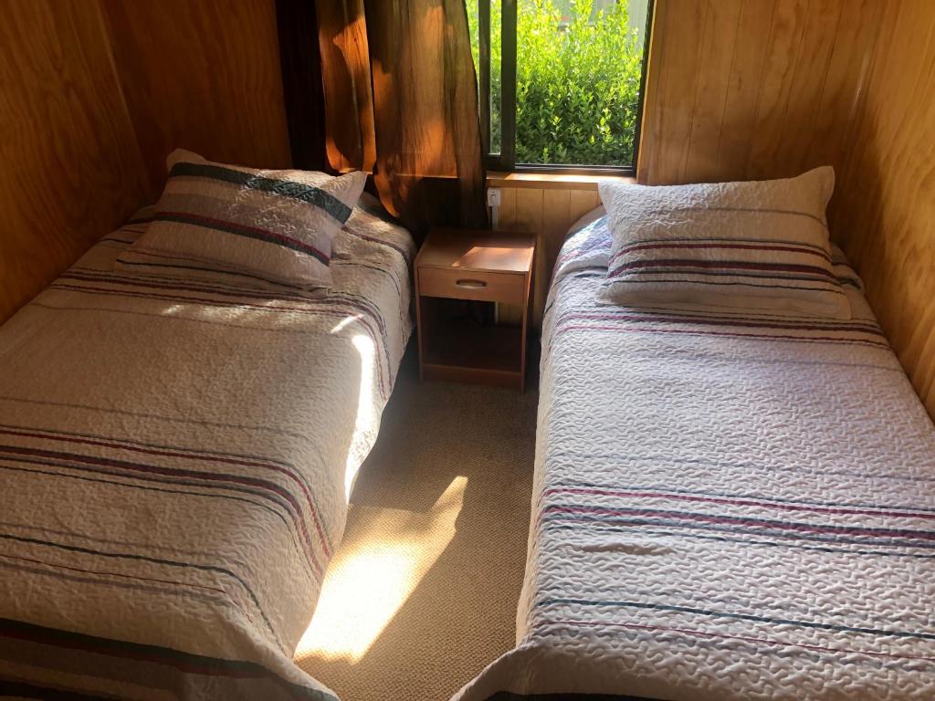Postel nebo postele na pokoji v ubytování Hostal Huepil